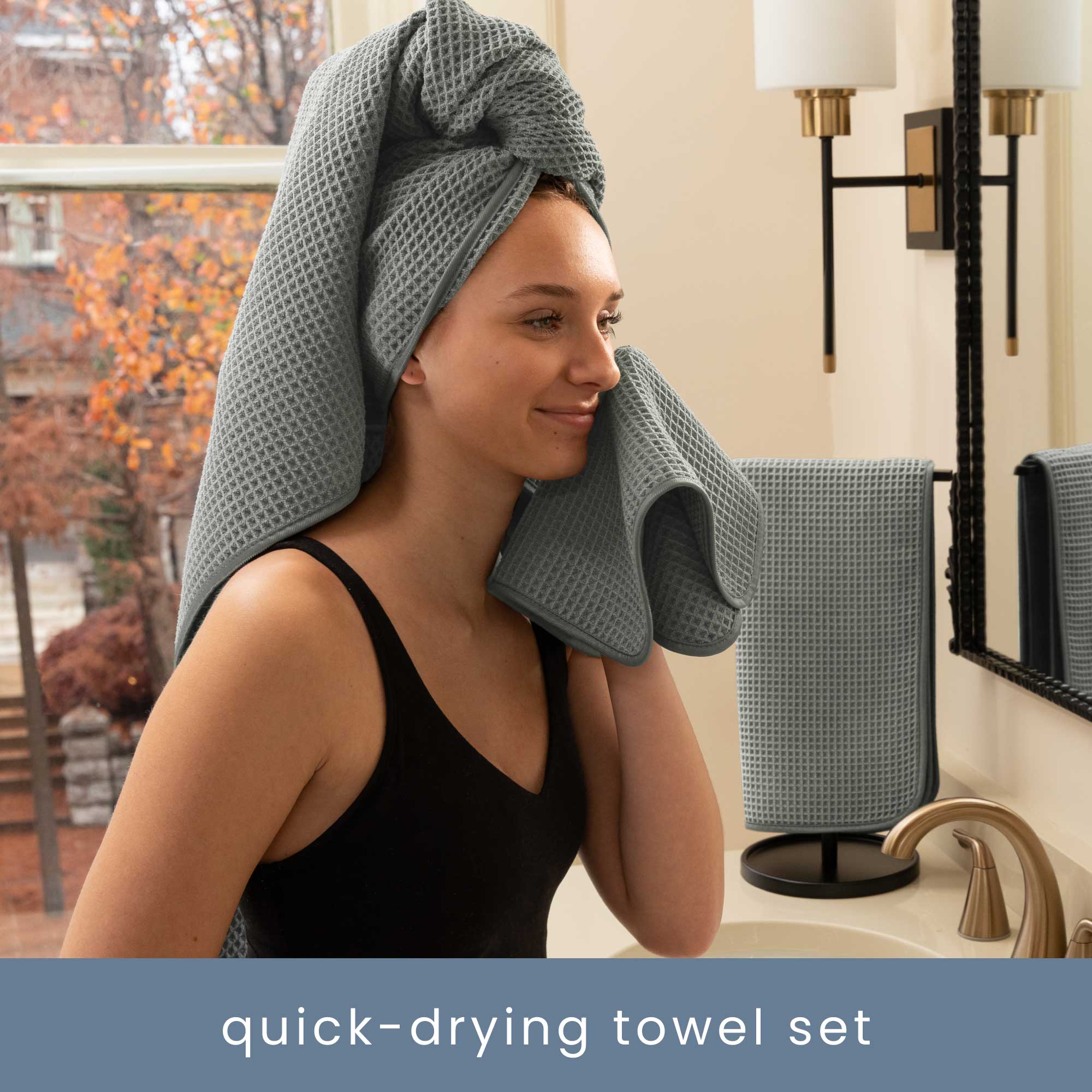 Woman using a grey, quick-drying waffle wash cloth in a bathroom.