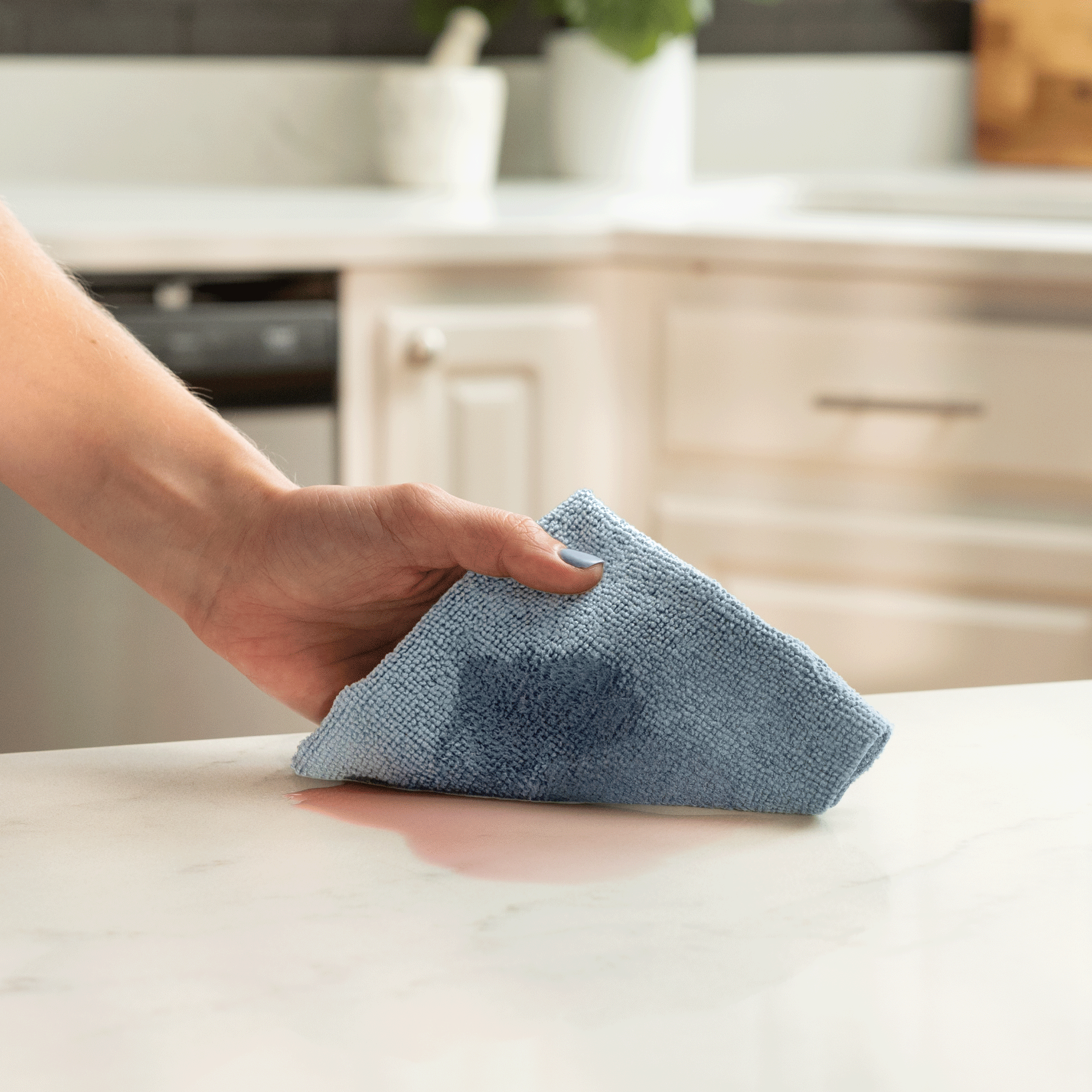 Microfiber cleaning cloth wiping up a spill with ease on a kitchen counter