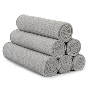 Grey honeycomb gym towels rolled and stacked
