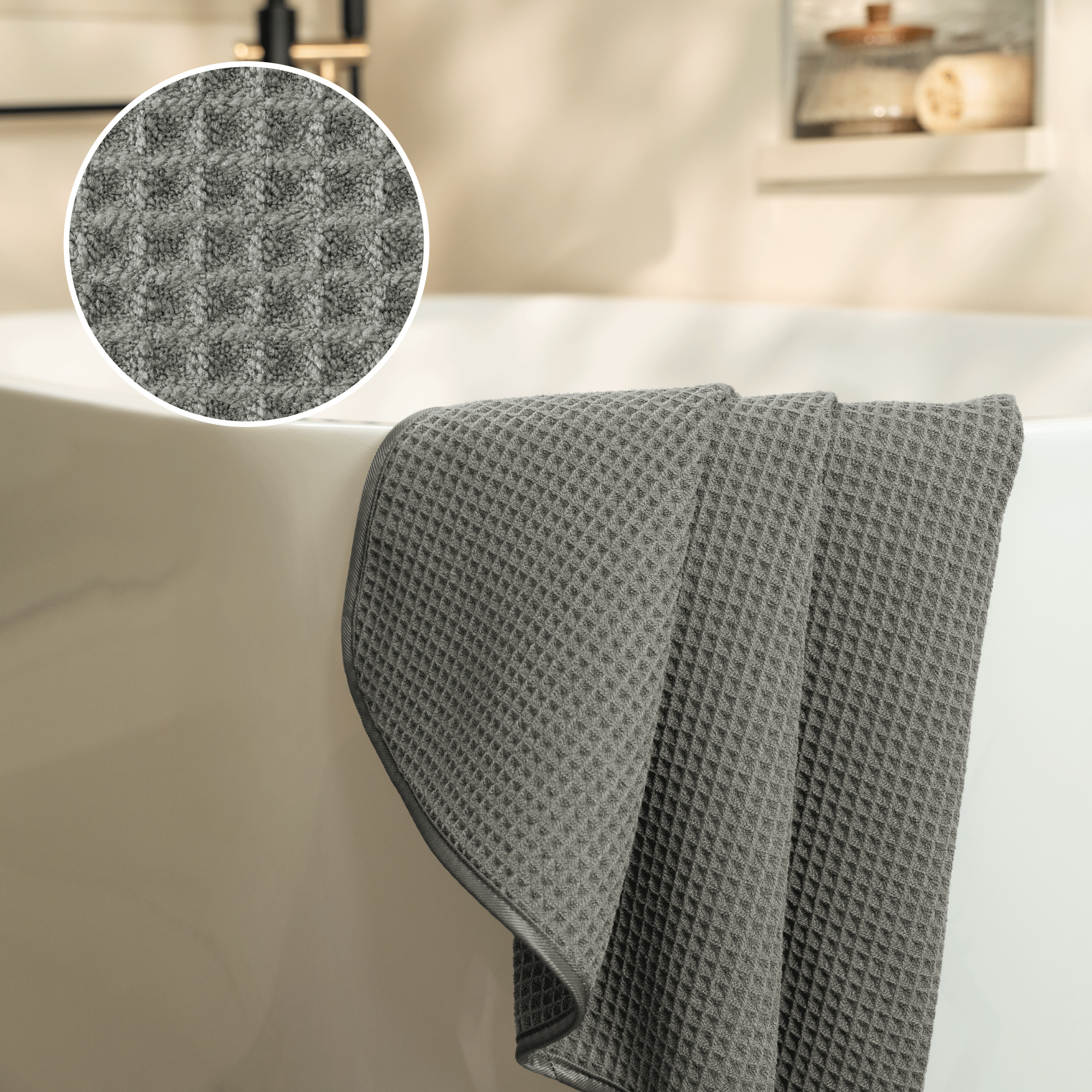 waffle texture shown closely with a grey waffle bath towel draped over the side of the tub