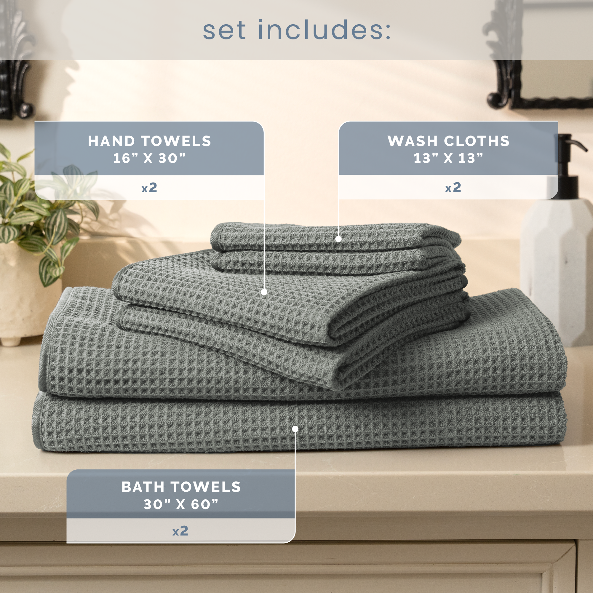 Set of grey towels including hand towels, washcloths, and bath towels on a bathroom counter.